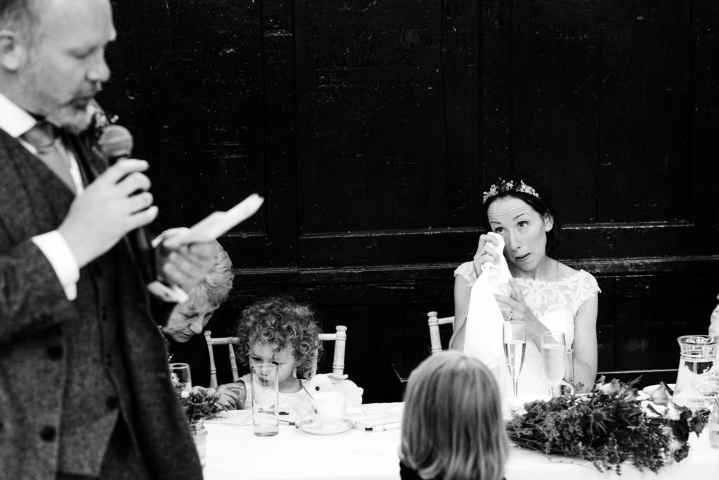 bride wiping her eye during speeches