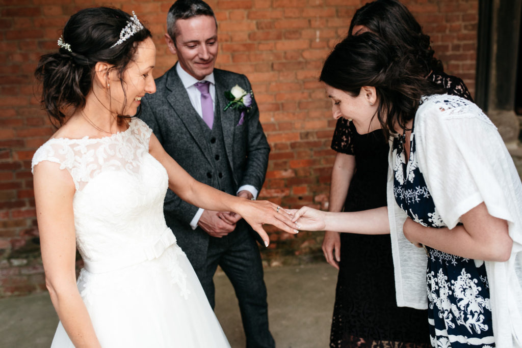 showing off her ring to guests