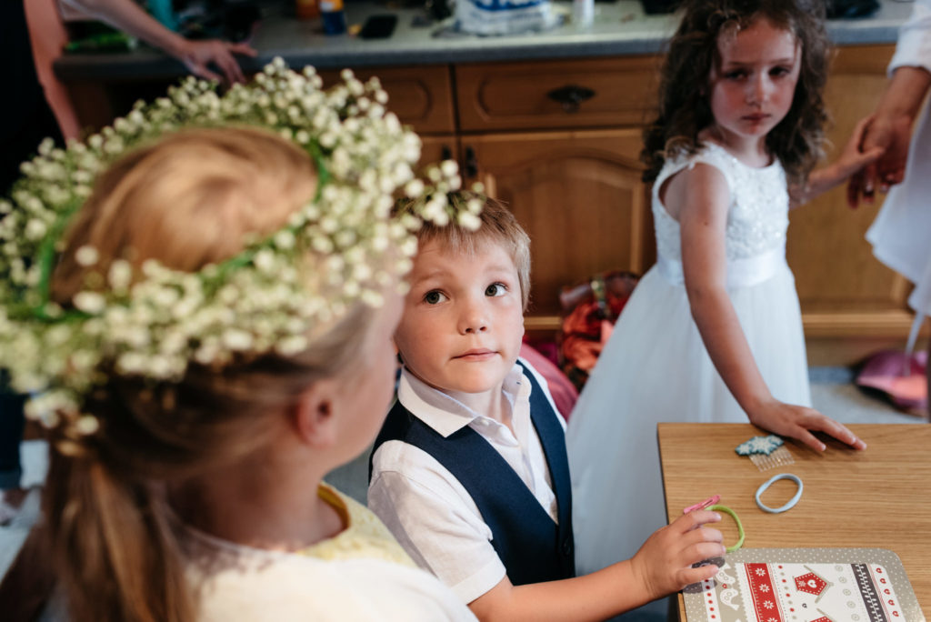 page boy looking at flower girl