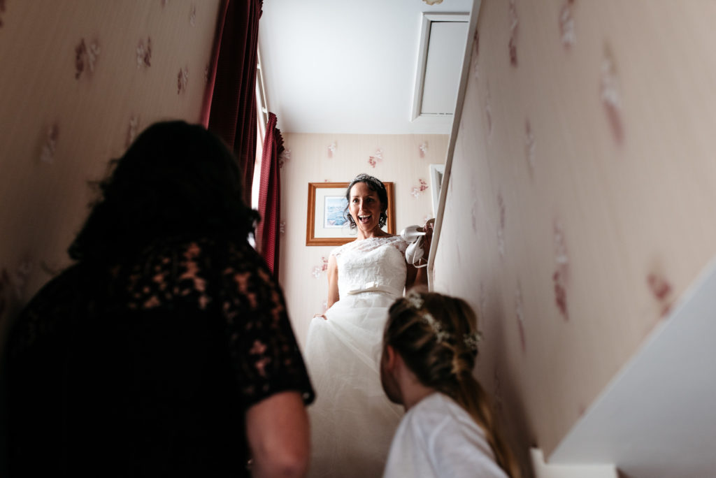 bride walking downstairs in her dress