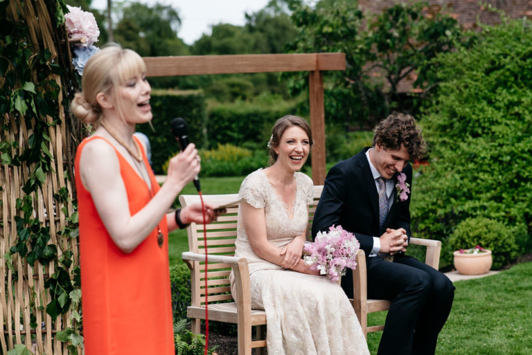 bride and groom laughing during reading