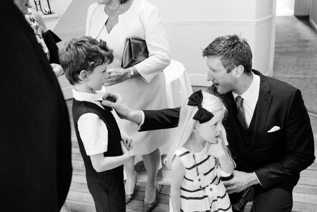 father straightens his sons tie