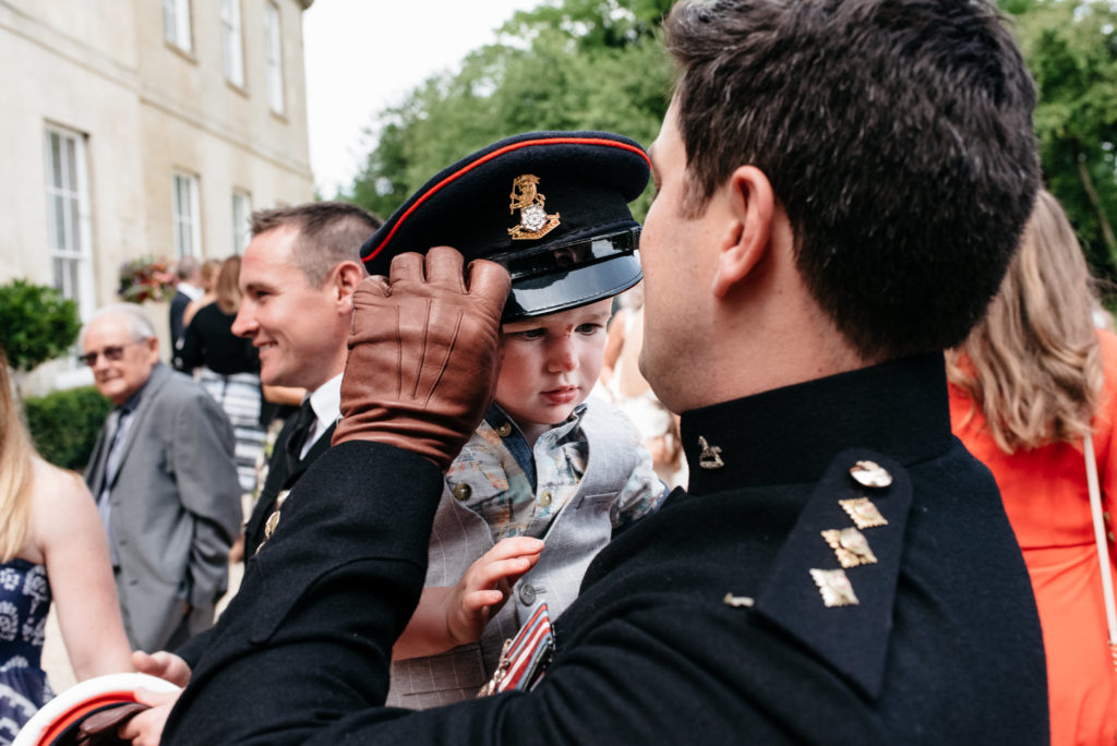 soldier lets his son wear his hat