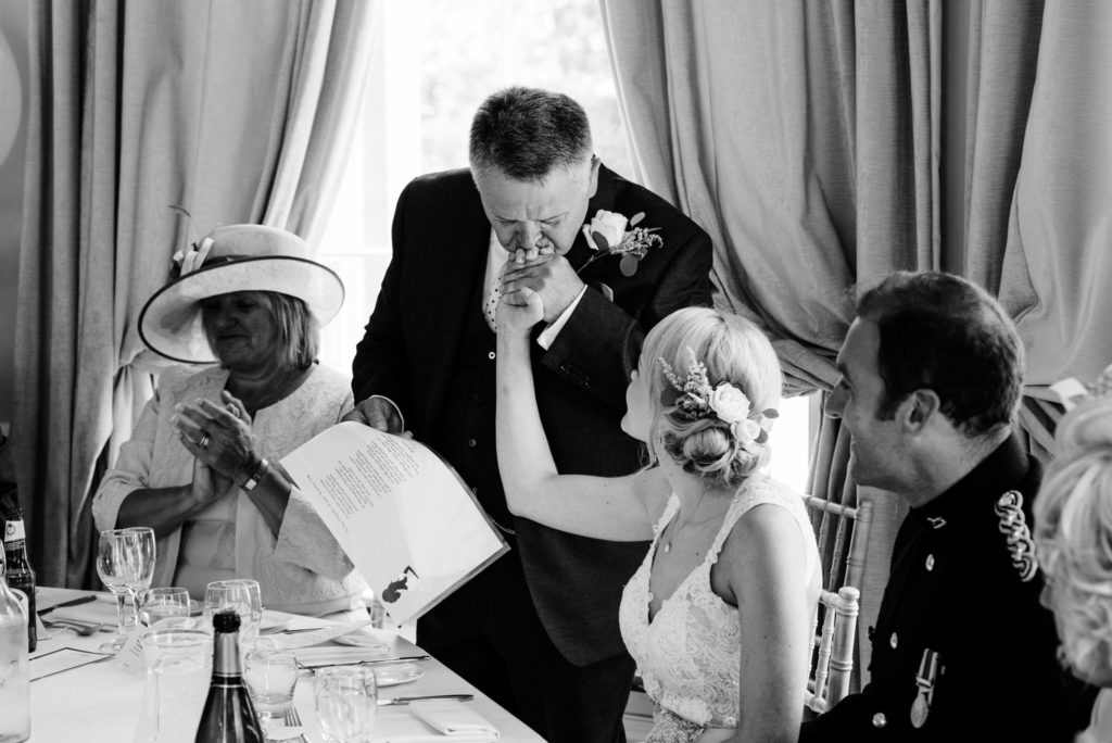 father of the bride kissing his daughters hand
