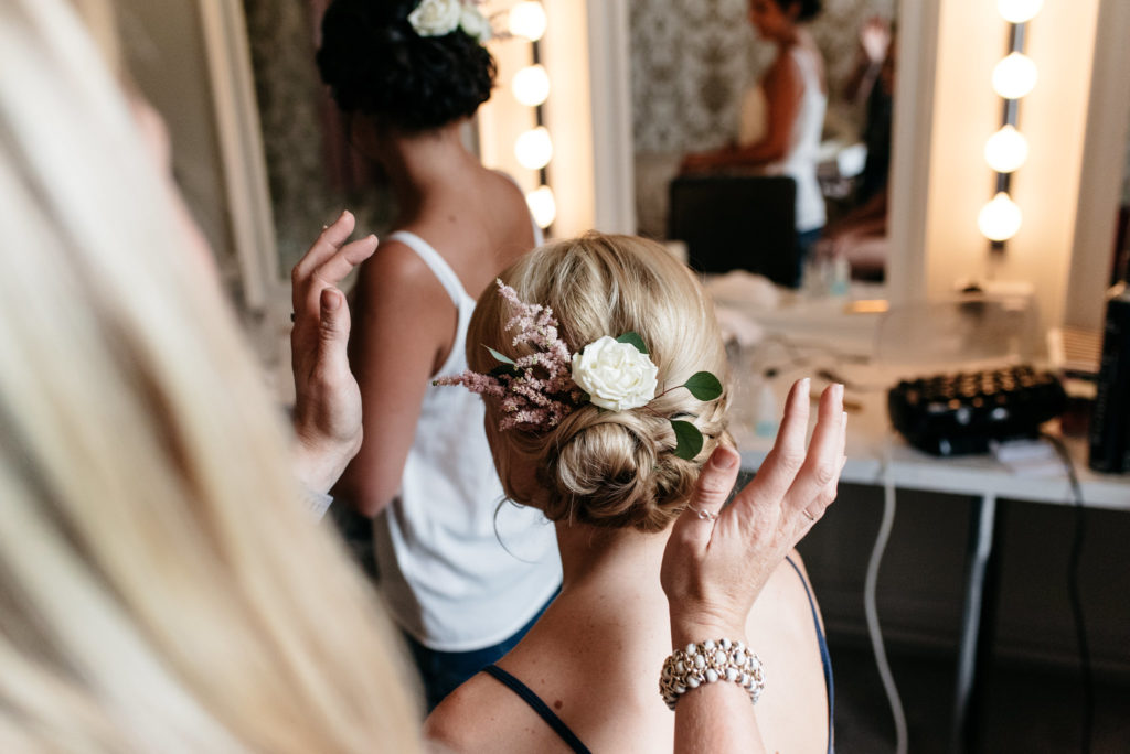 hair stylist admiring brides hair