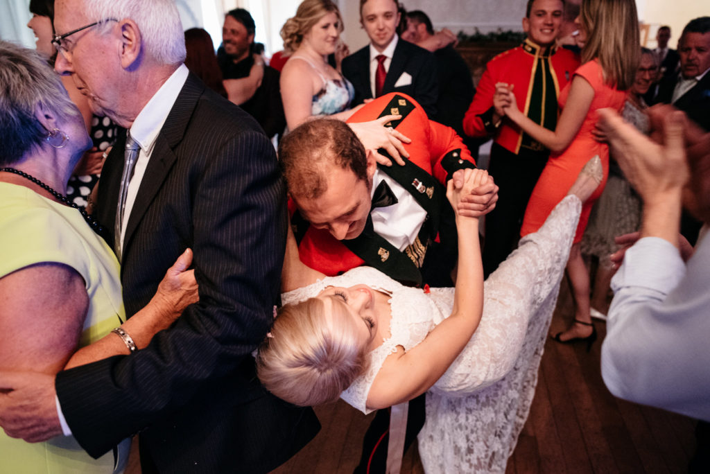 groom dips bride while dancing