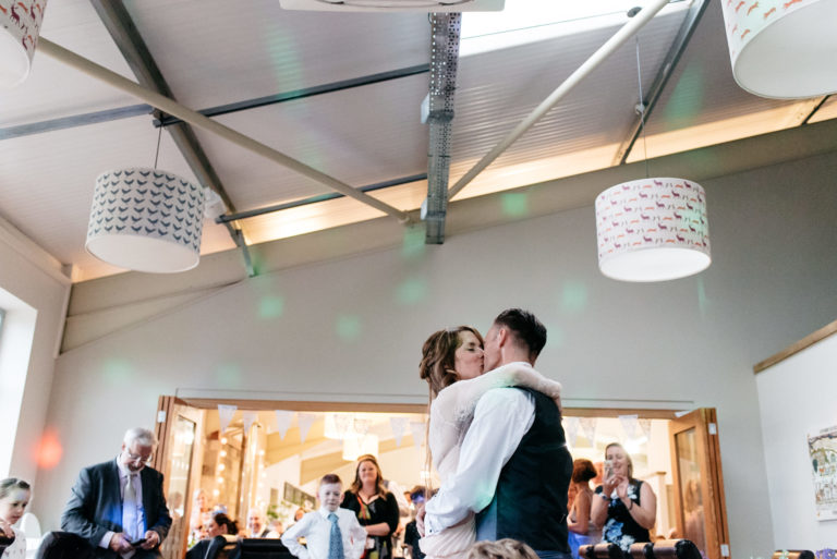 bride and groom kissing on the dance floor