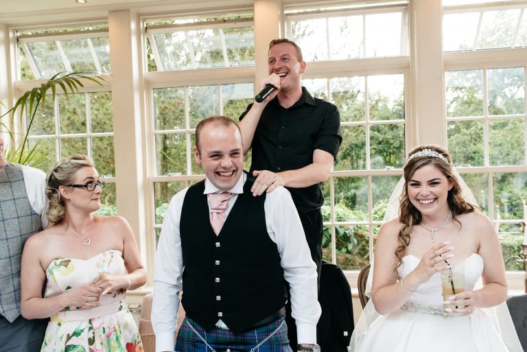 singing waiter with bride and groom