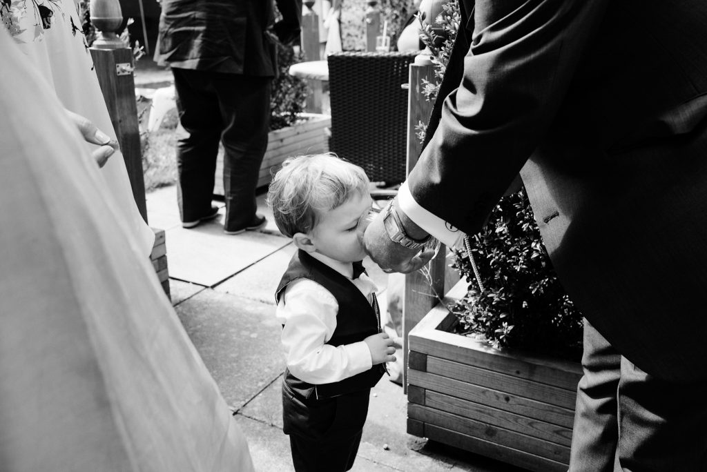 little boy receiving a drink