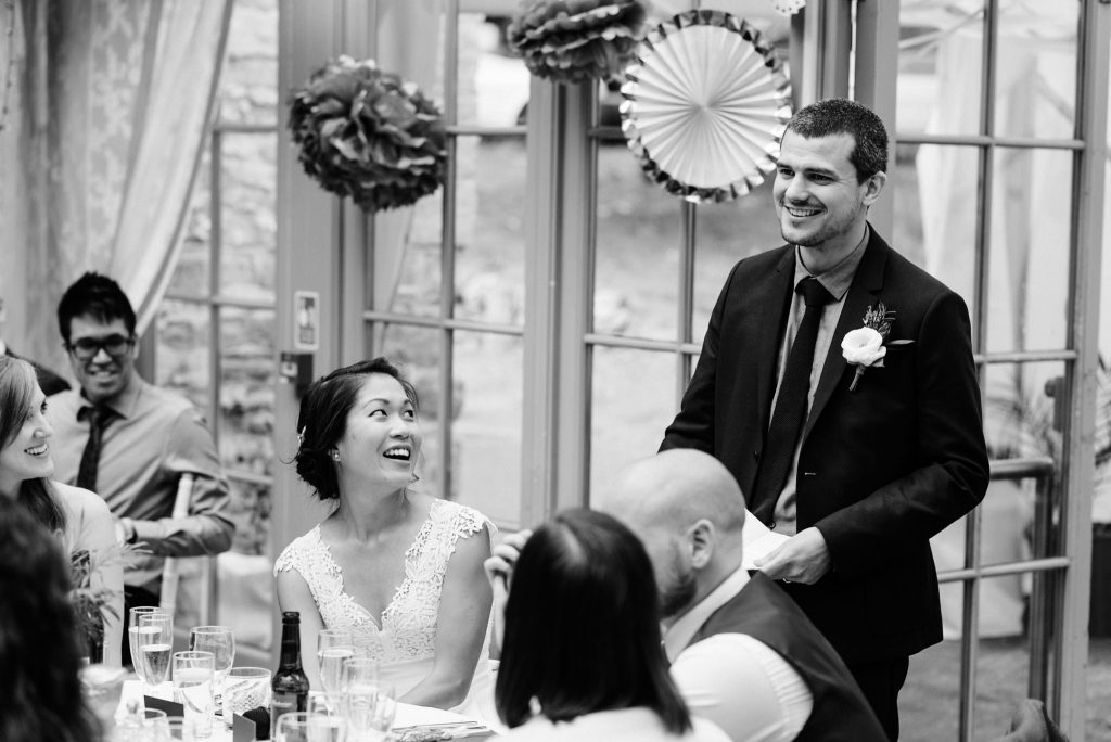bride looking at groom during speech
