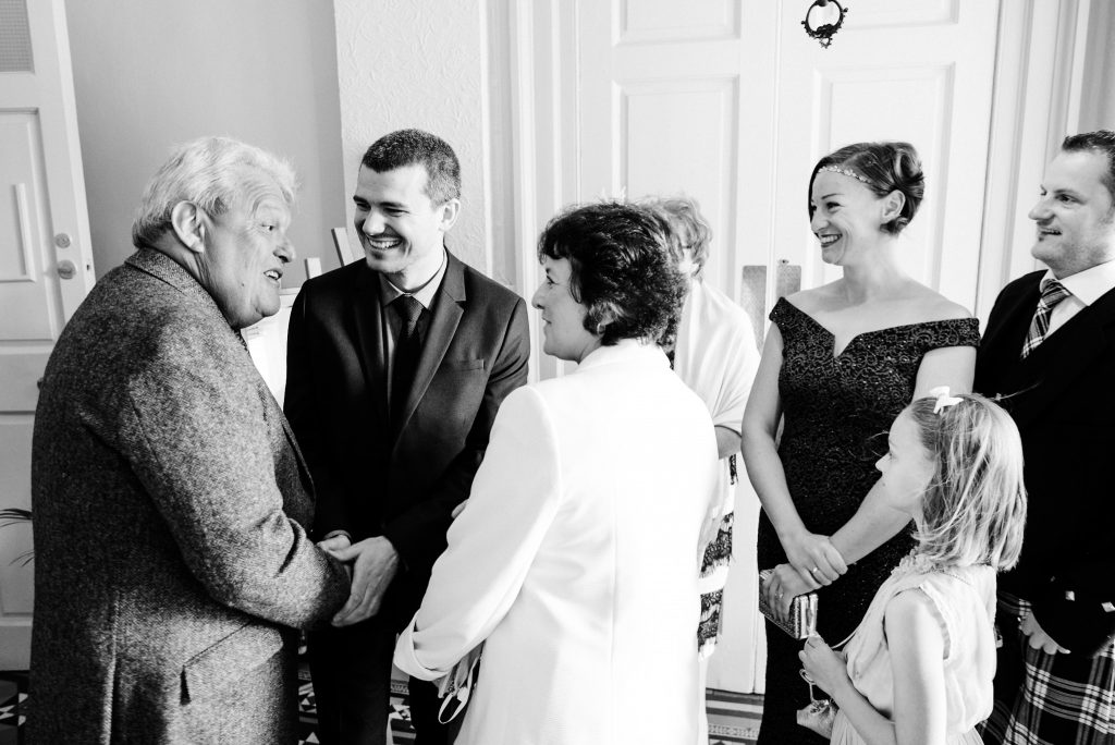 groom greeting guests