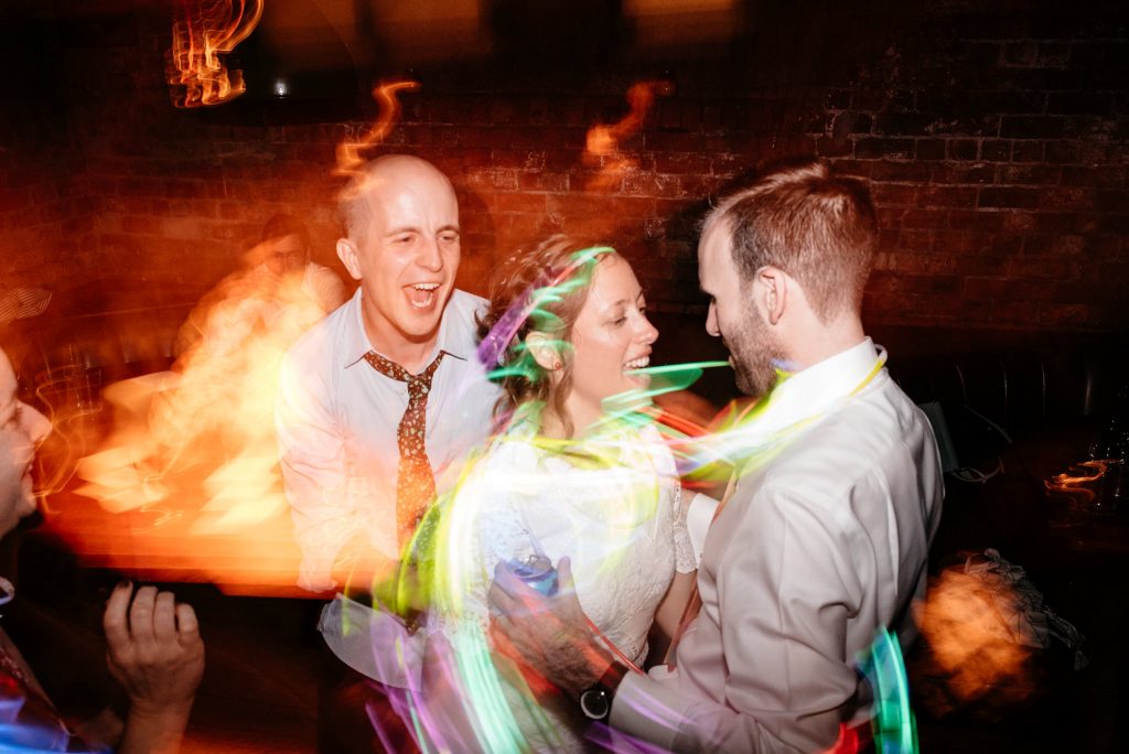 newlyweds on the dance floor with glow sticks
