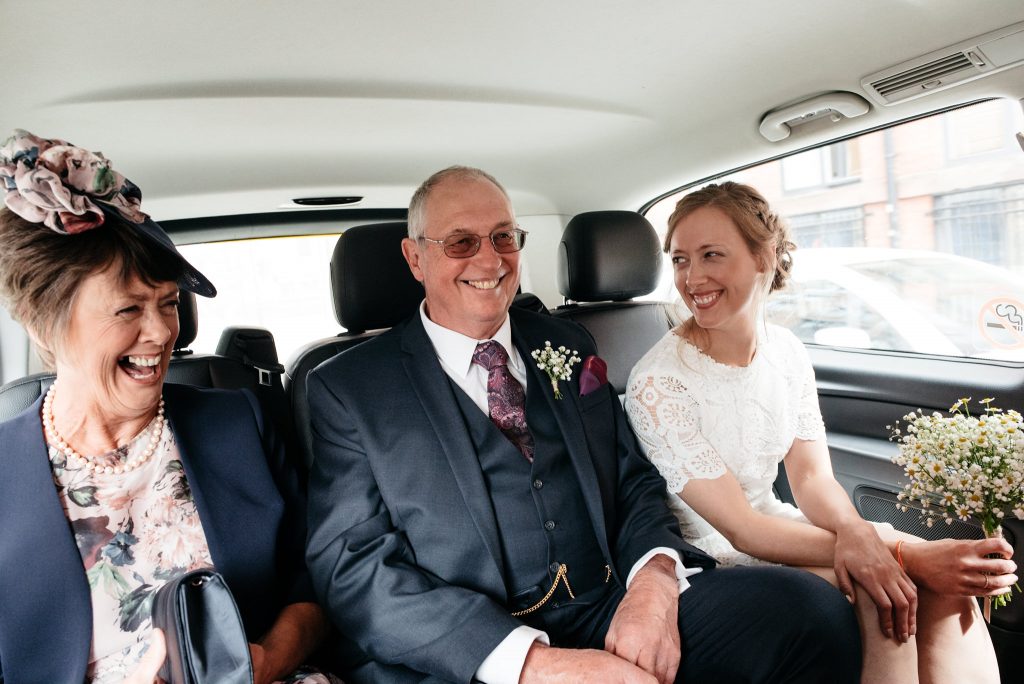 inside a taxi with her parents