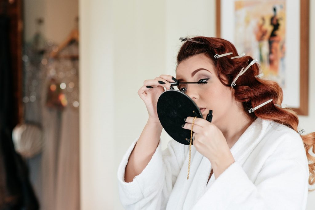 bride putting mascara on