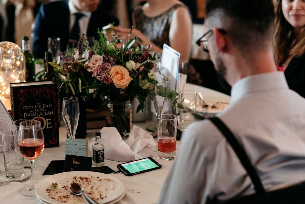 groomsman watching football on his phone