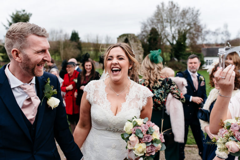 bride and groom laughing together