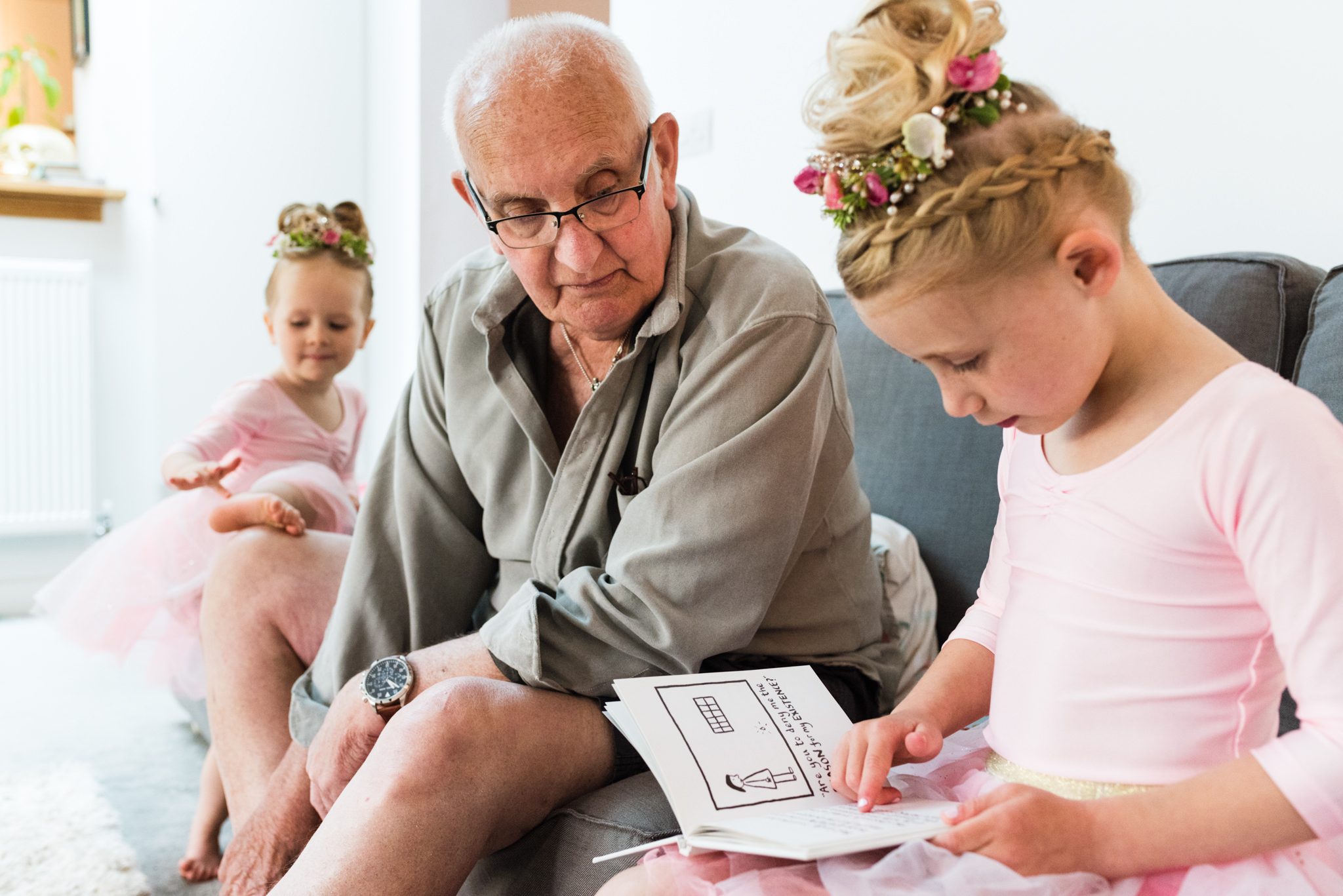 kids reading with grandad