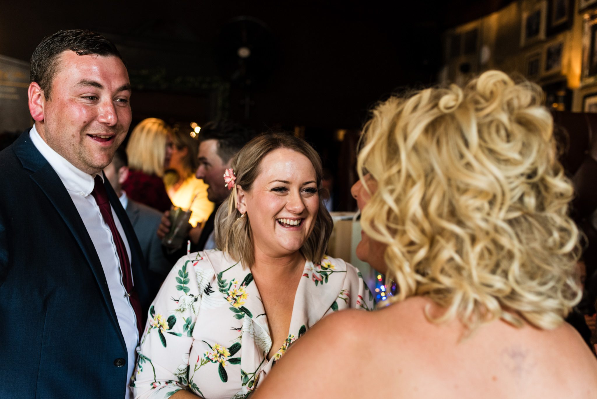 smiling guests greet bride