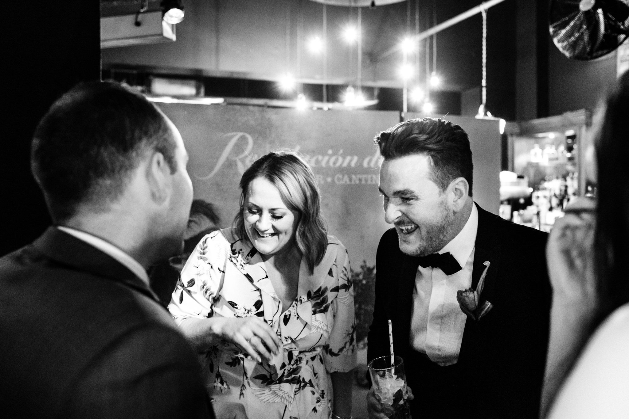 groom laughing with guests