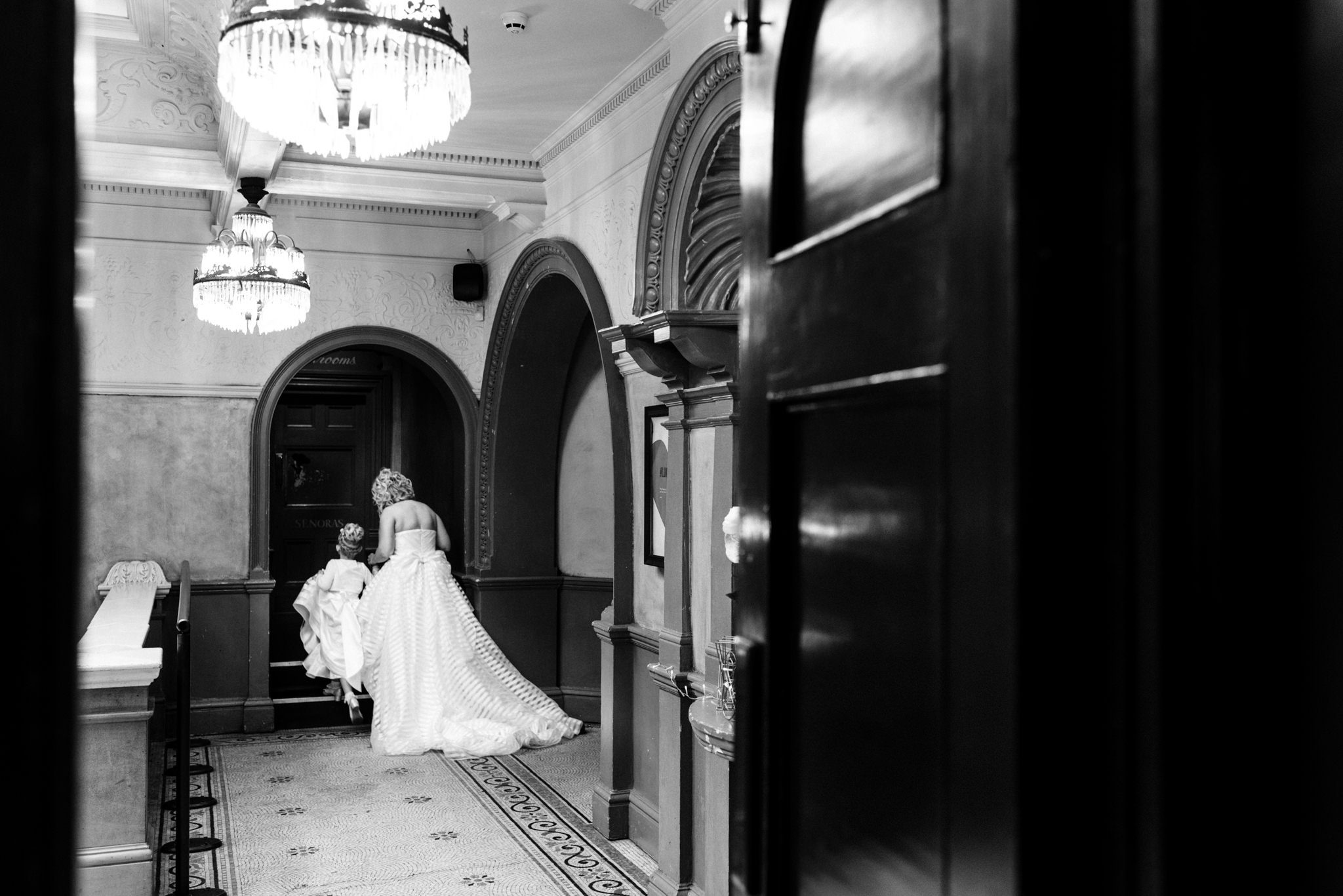 bride taking her daughter to the bathroom