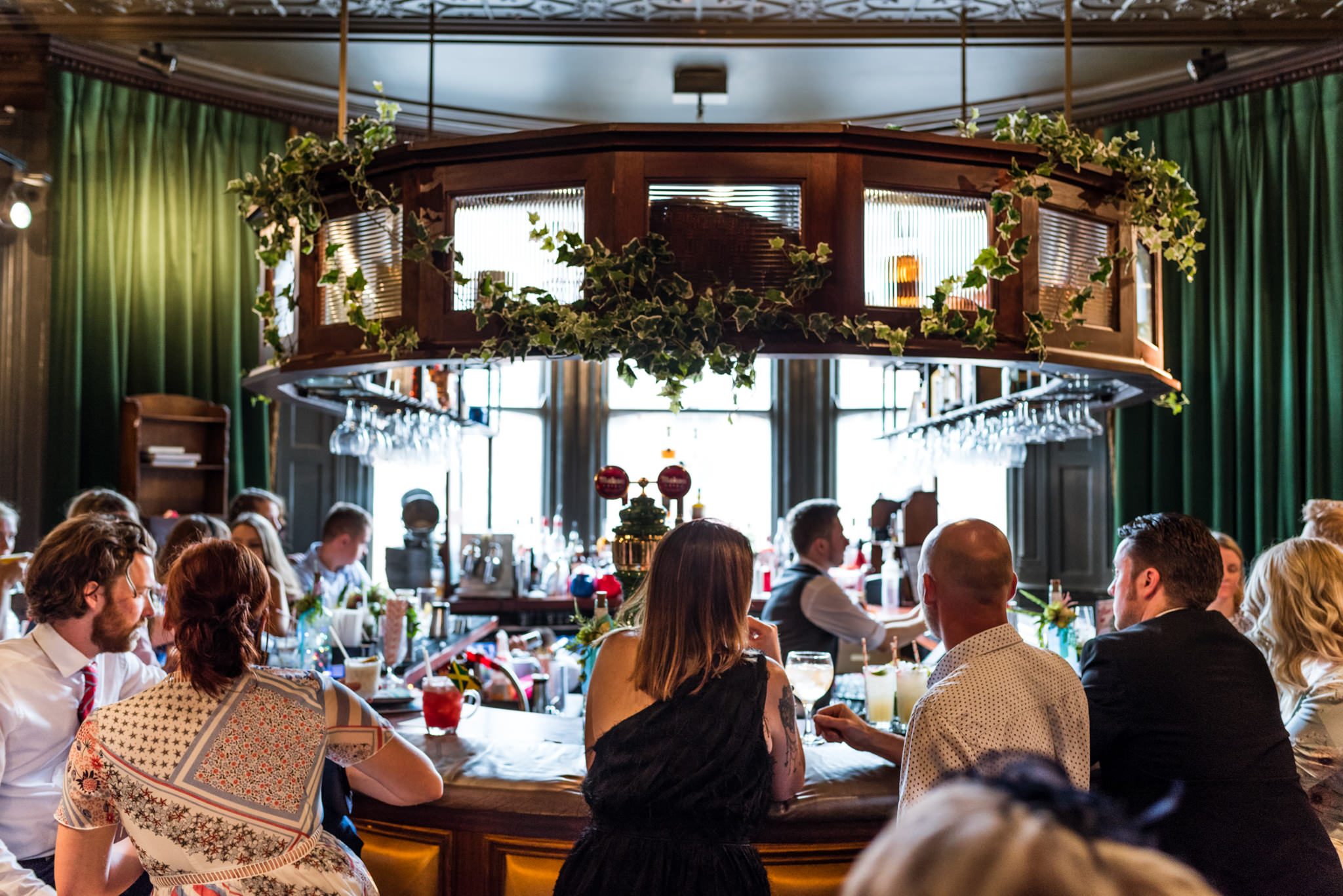 wedding guests sat at the bar