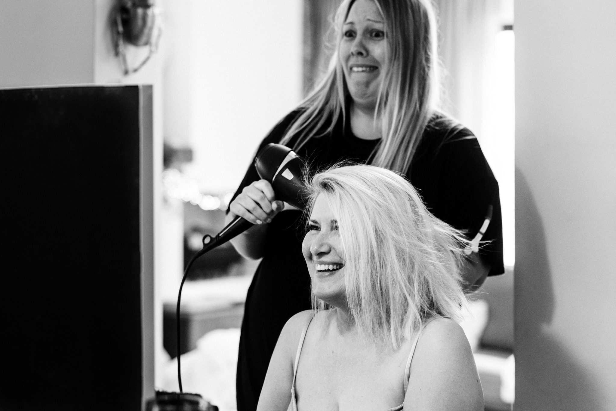 bride laughing having her hair styled