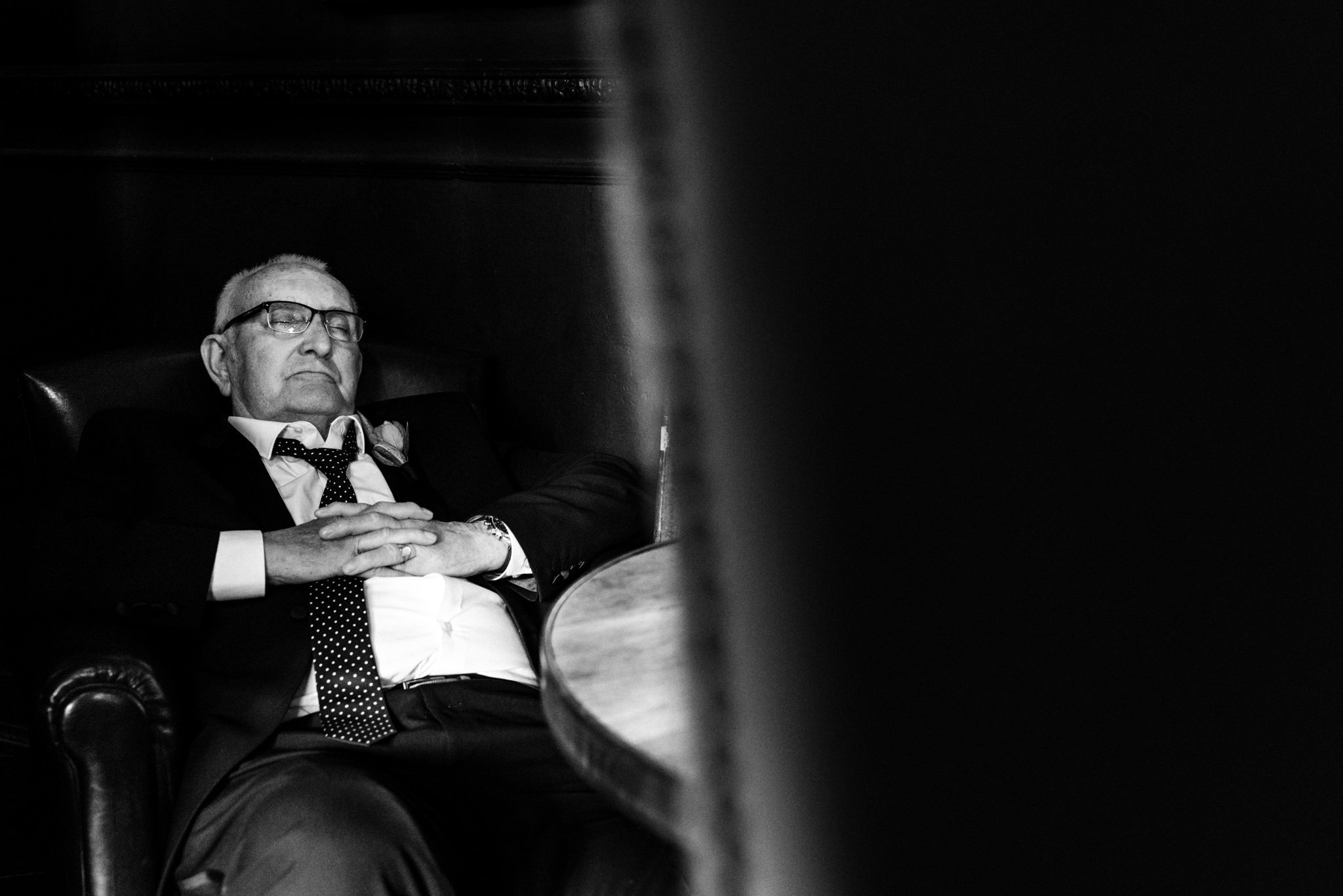 father of the bride asleep in a chair
