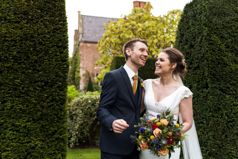 relaxed couples portraits in front of main house