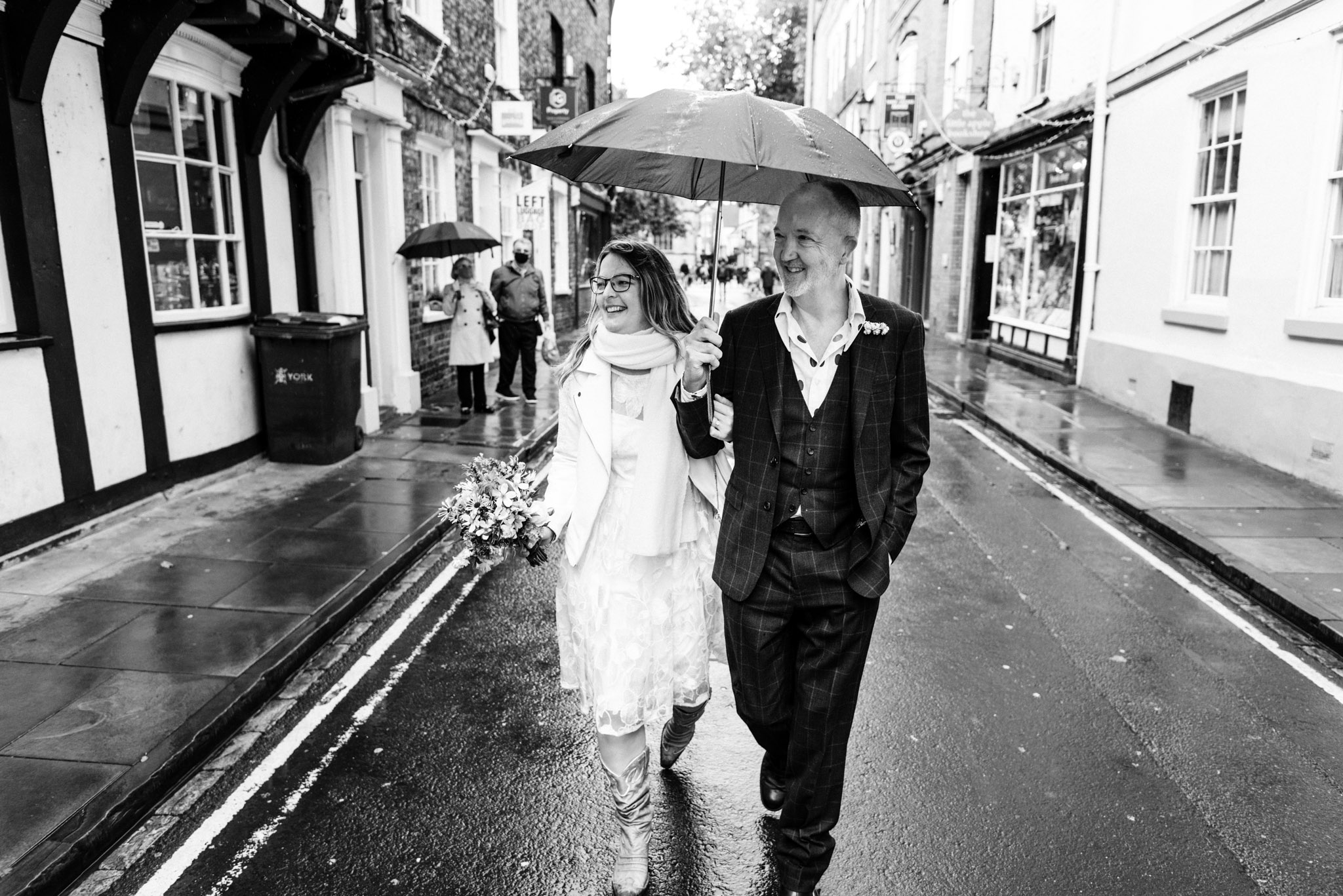 bride and groom walking through york for their micro wedding