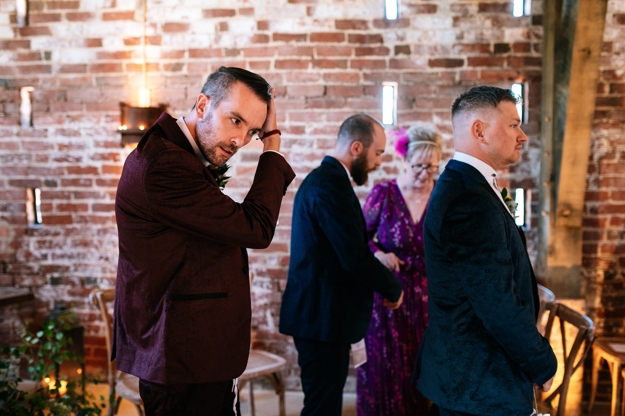 nervous groom fixing his hair before the ceremony