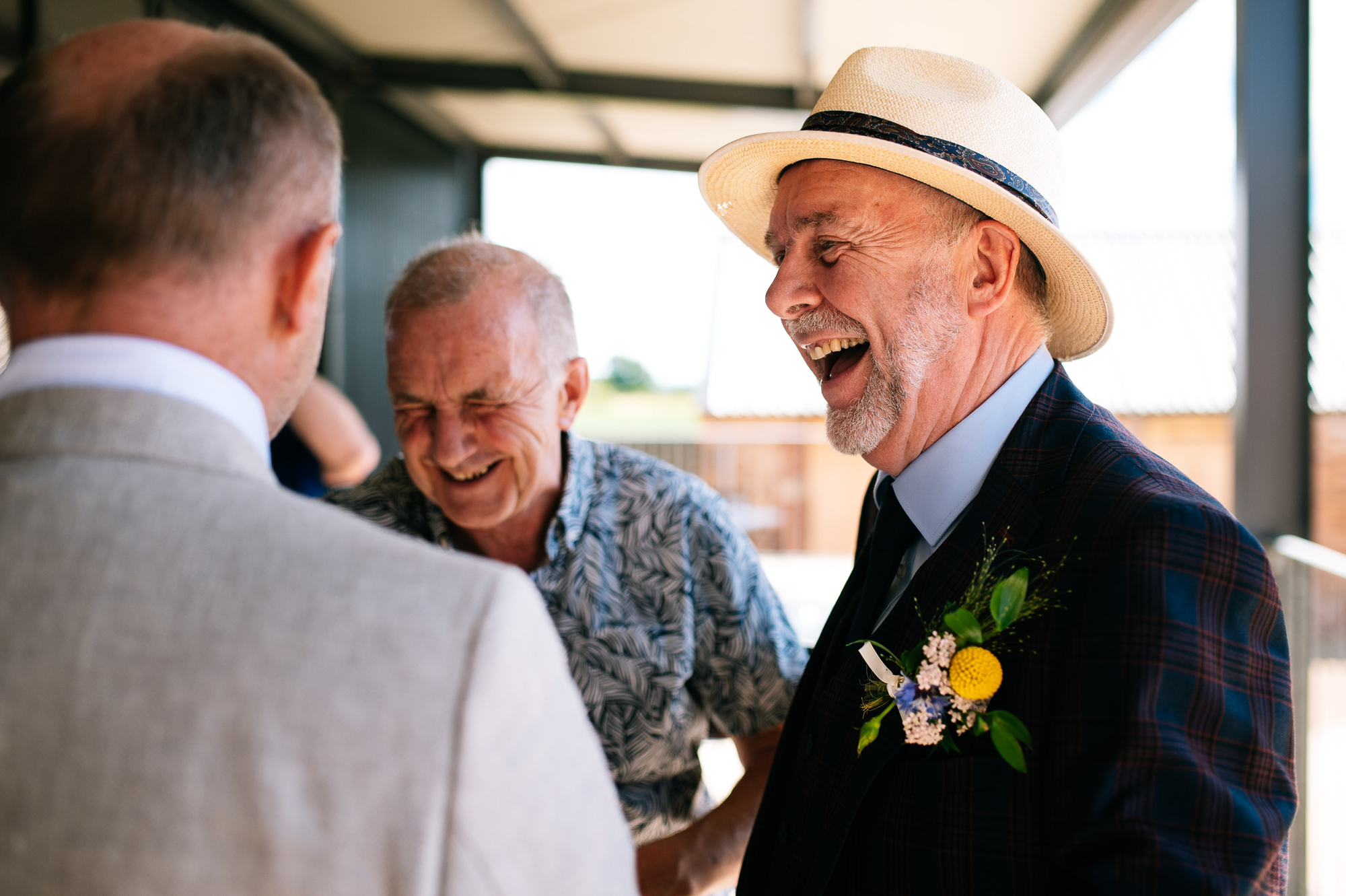 groom's dad having a laugh with friends