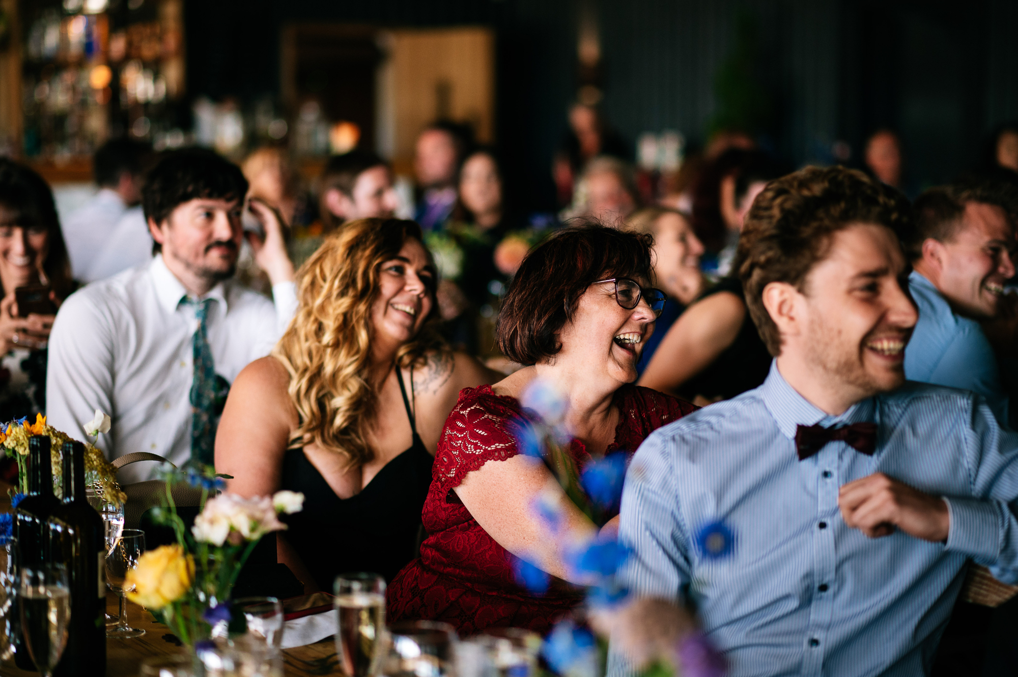 wedding guests laughing at speeches