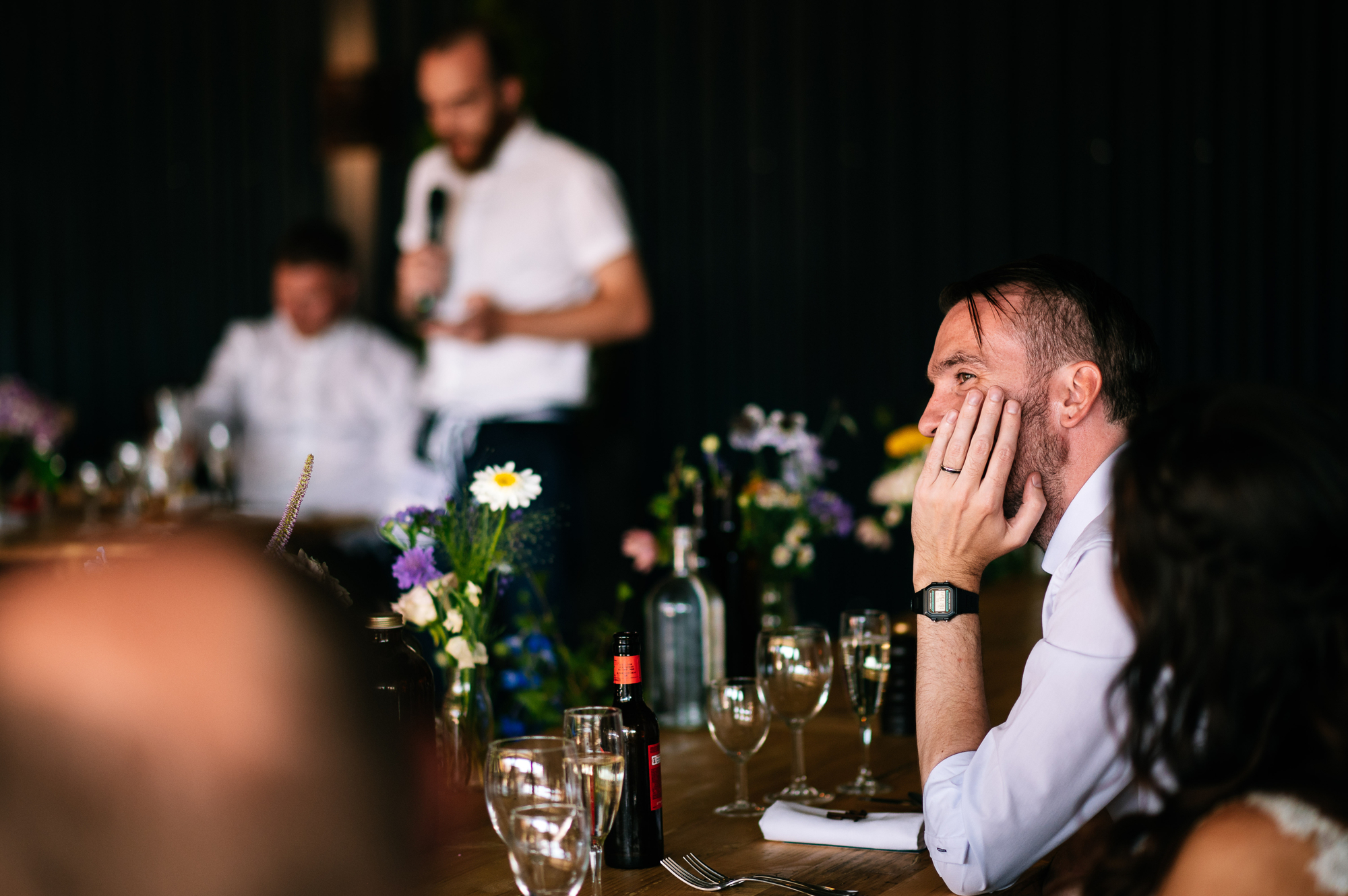 thoughtful groom during the speeches