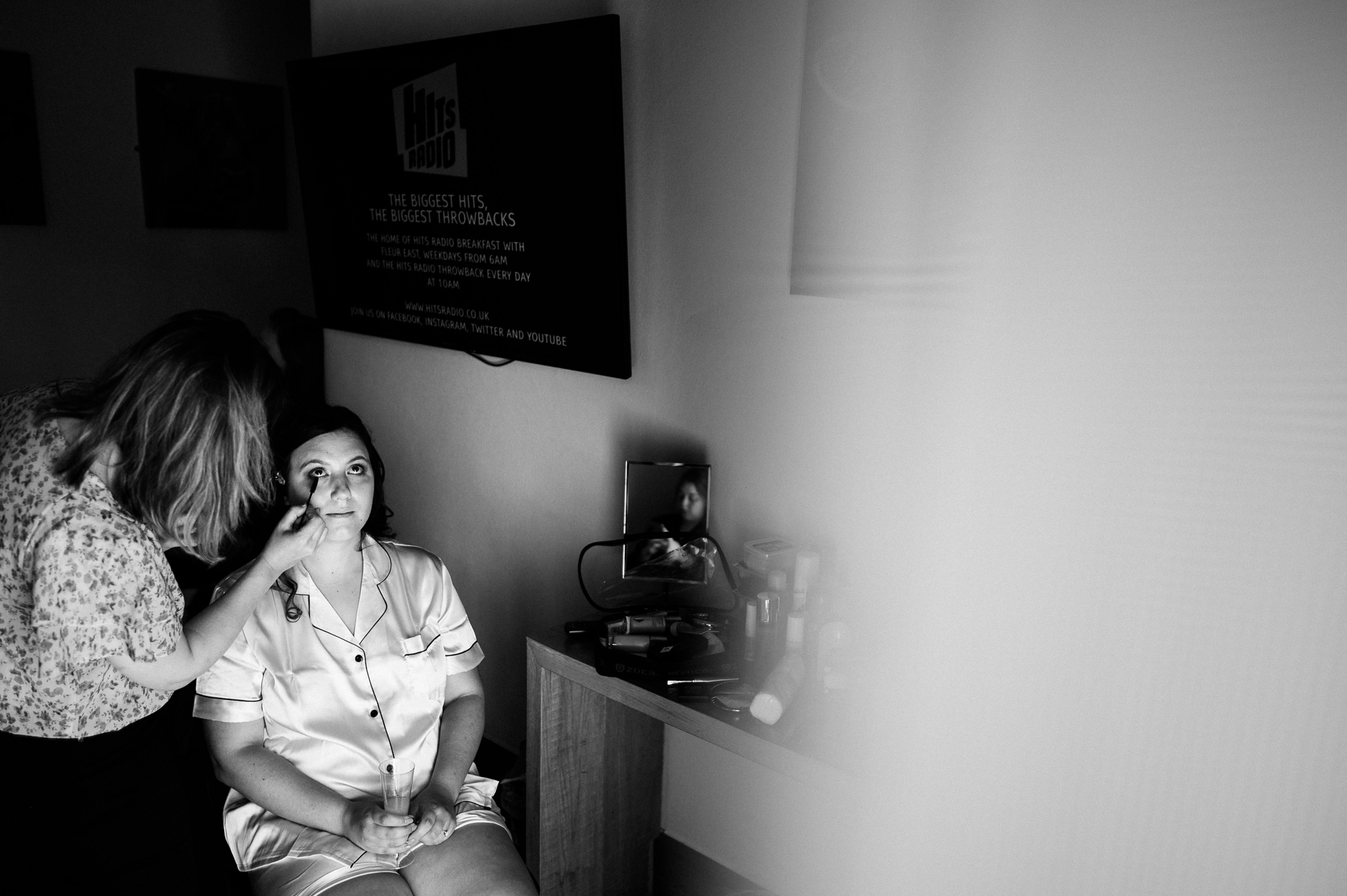 bride wearing pyjamas having her makeup done