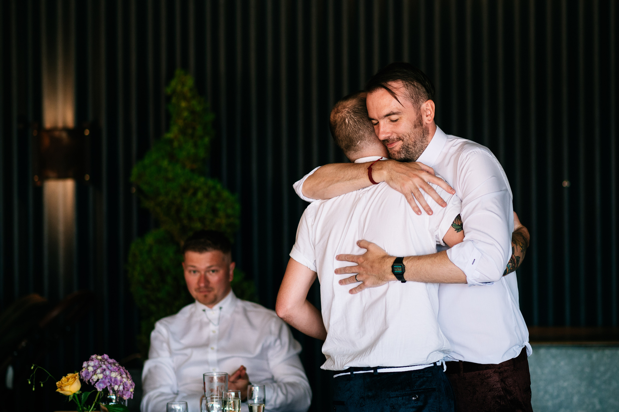 groom hugging his brother after the speeches