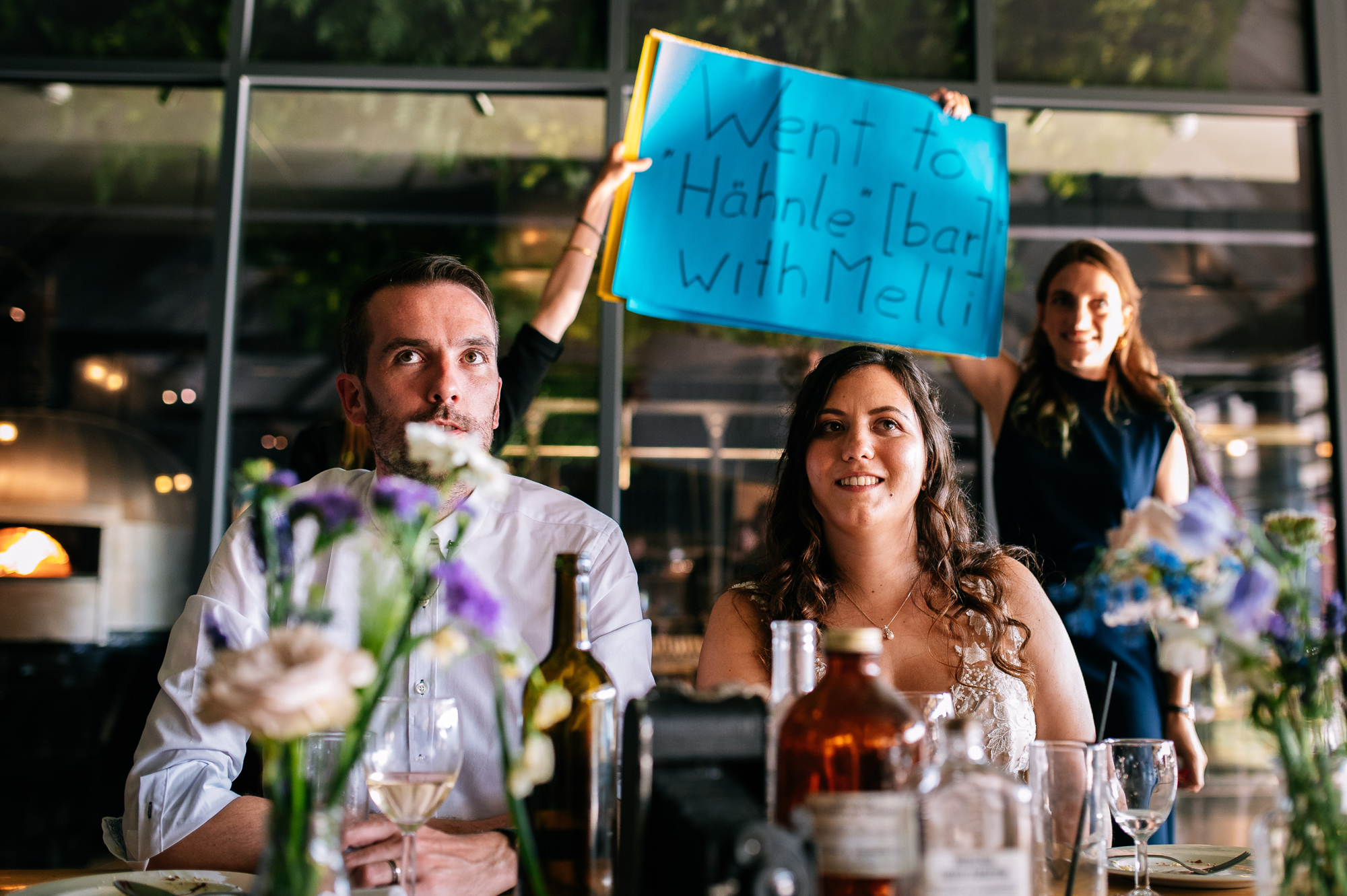 bride and groom game with sign behind them