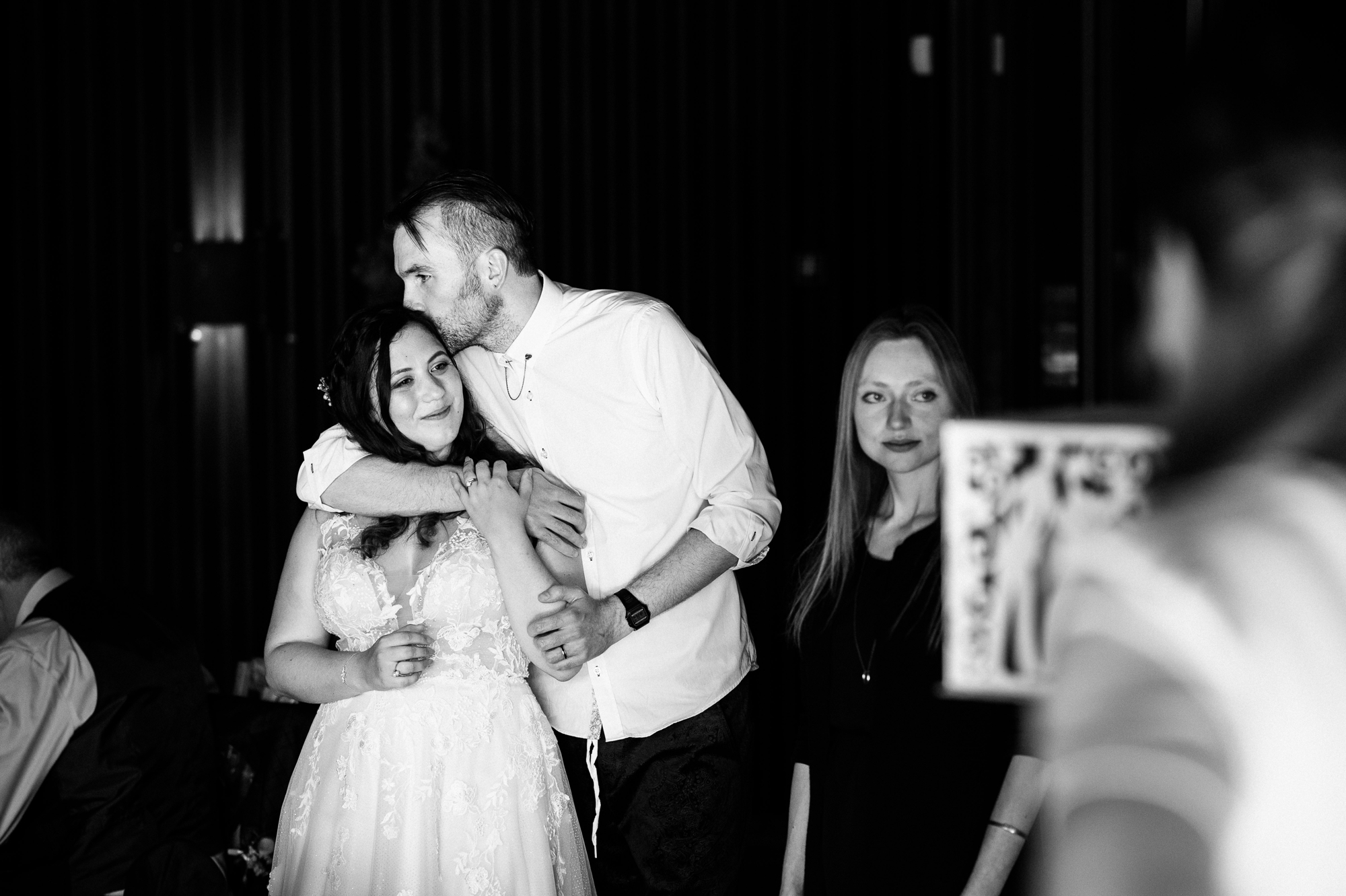 groom kissing his new wife during a speech