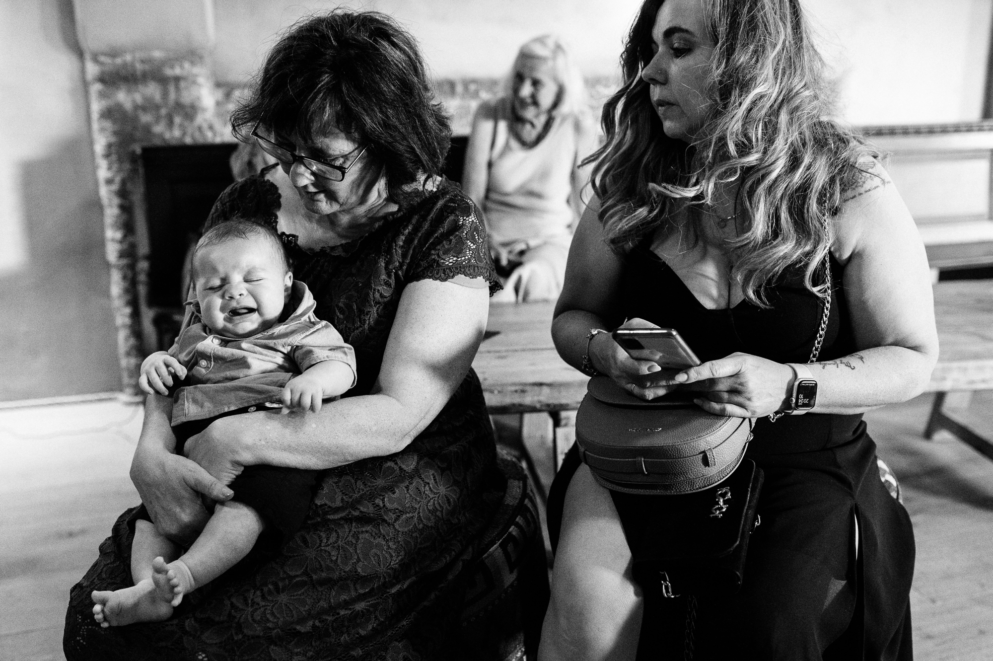 two women caring for a crying baby