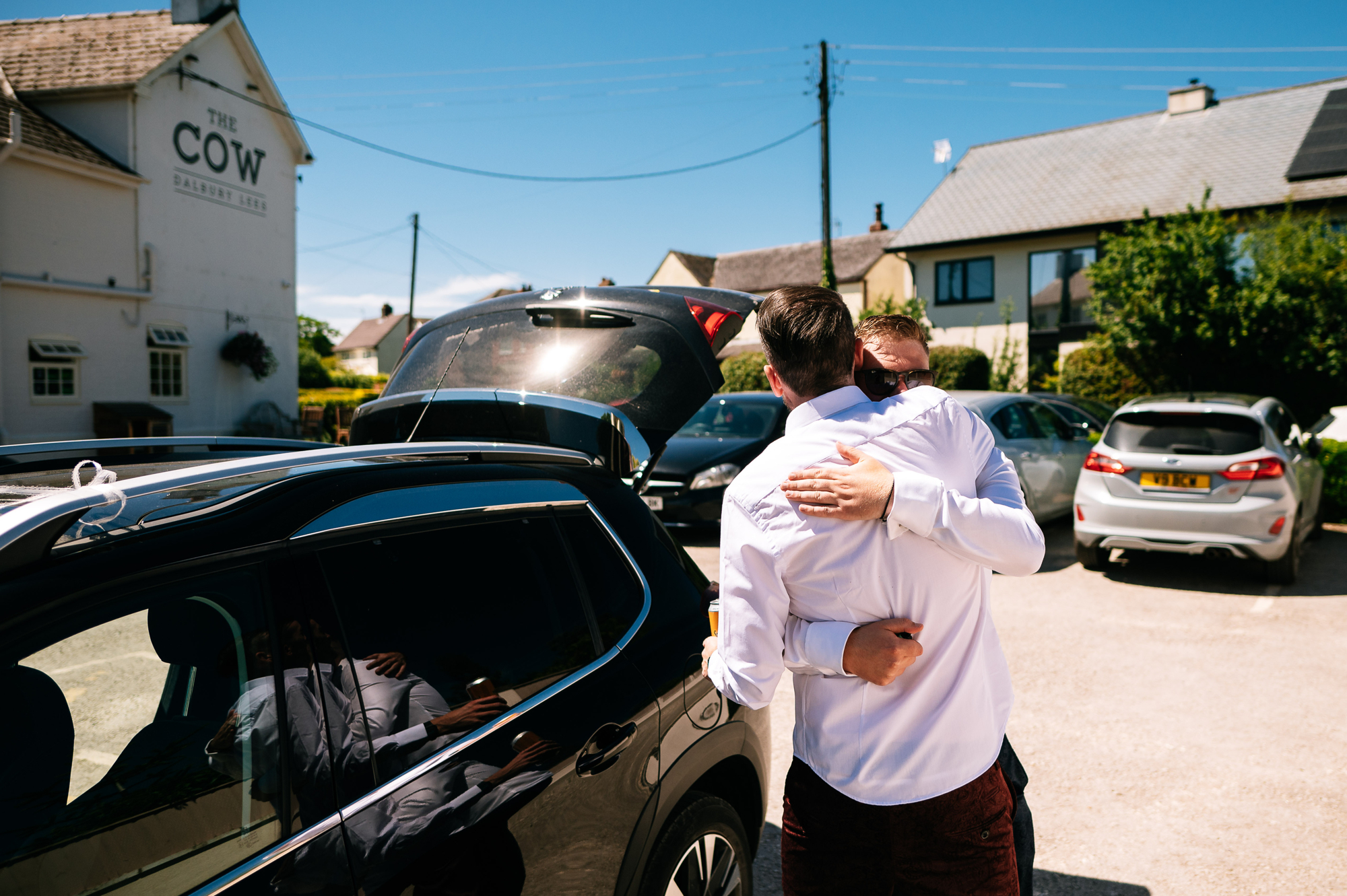 groom hugging one of his groomsmen