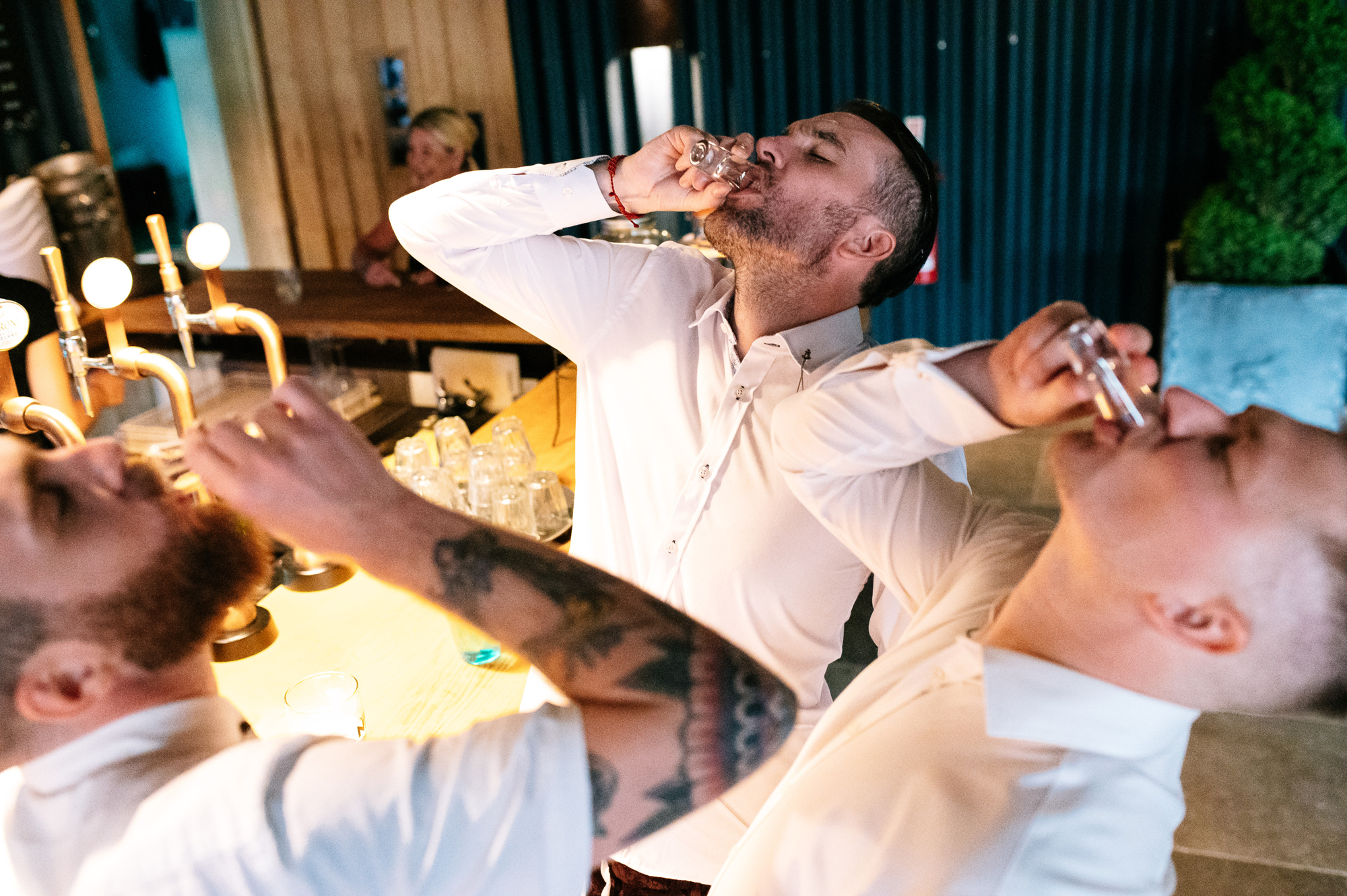 groom taking shots of tequila with his friends