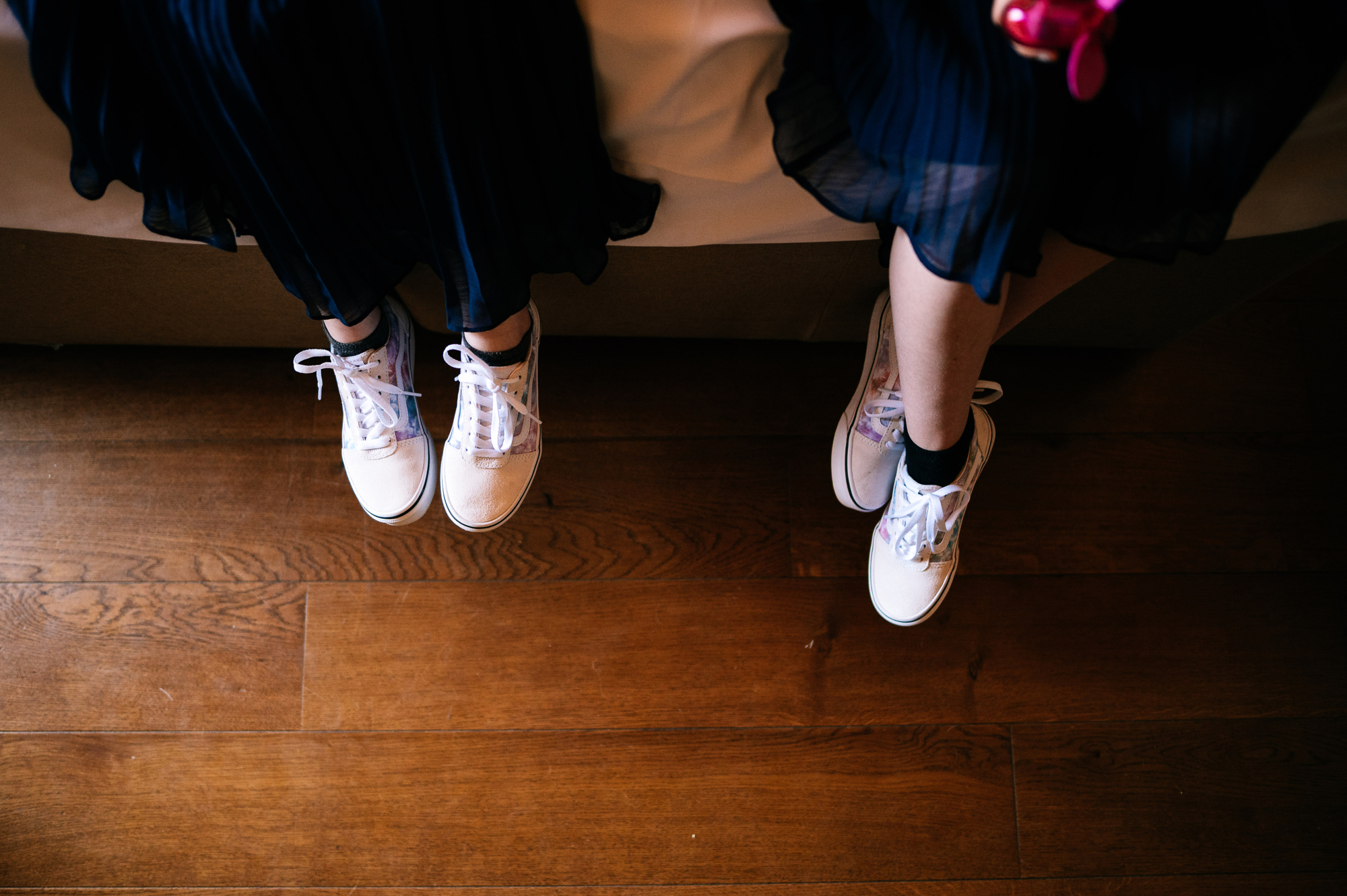 flower girls feet wearing white trainers
