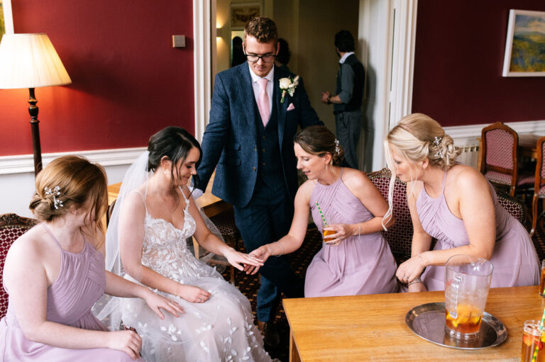 bridesmaids admiring the brides wedding ring