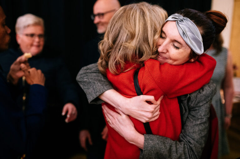 smiling bride hugging guests