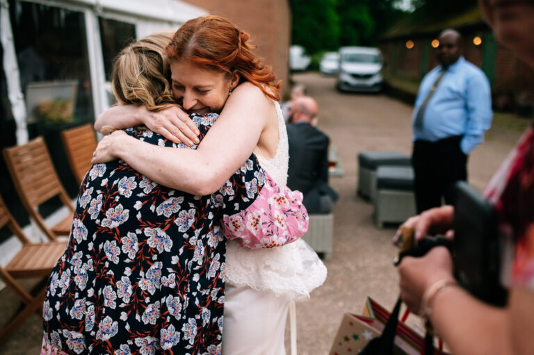bride hugging her friend at foremark cottages