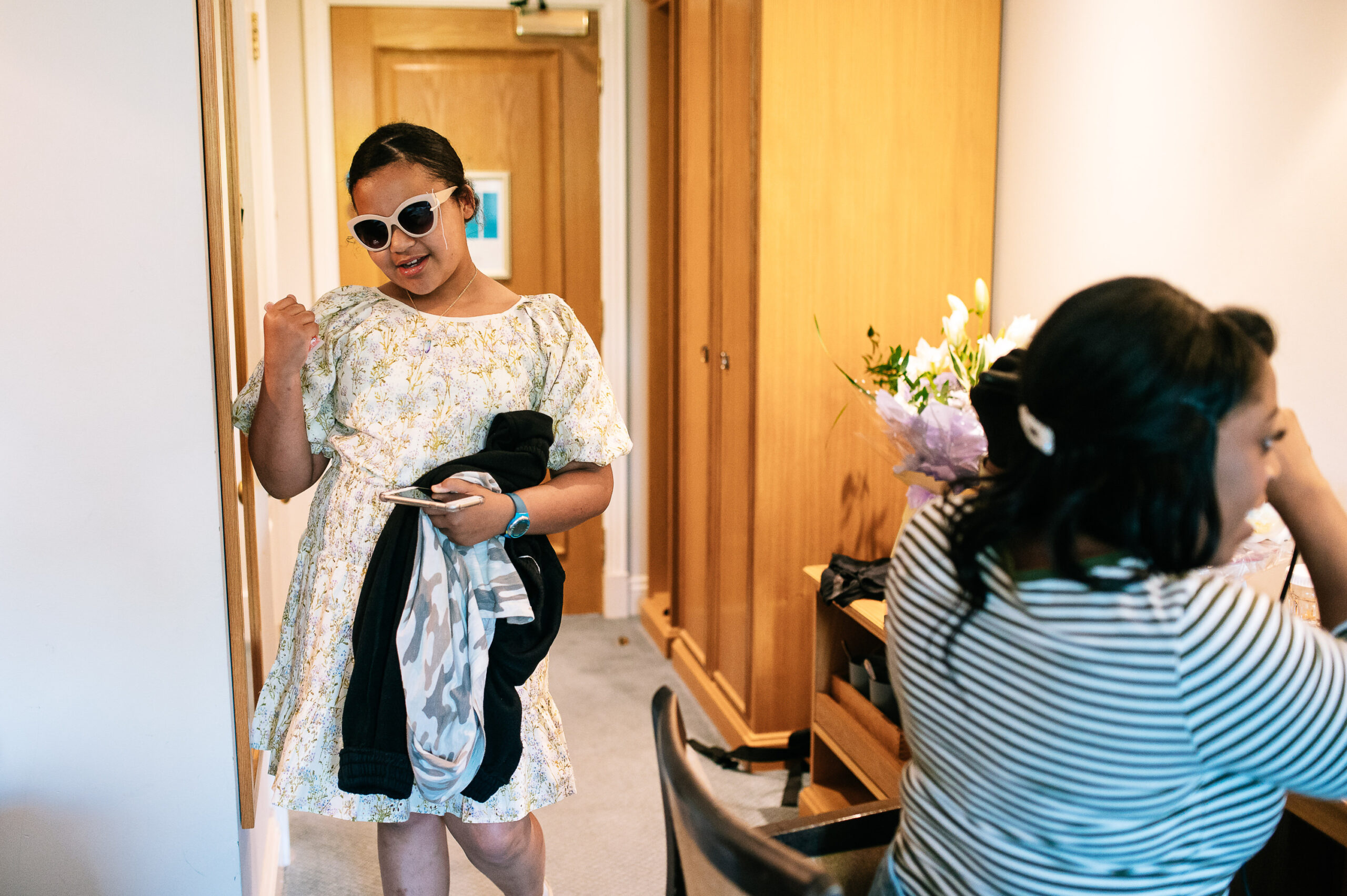 girl trying on sunglasses indoors