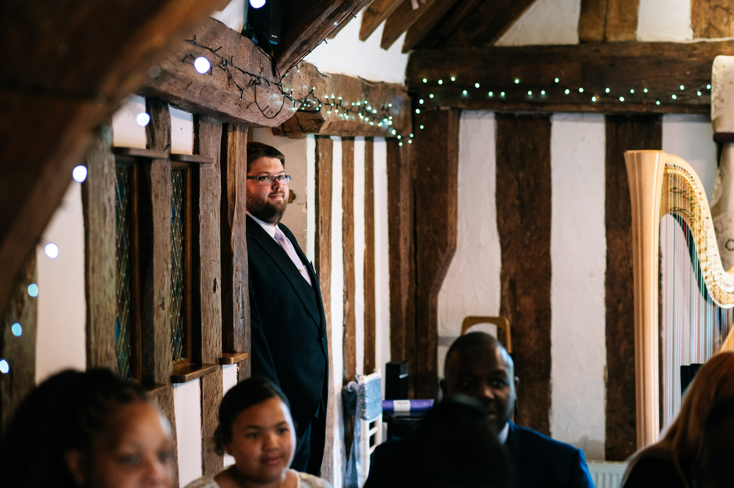 groom having a peek at the ceremony room at the moat house