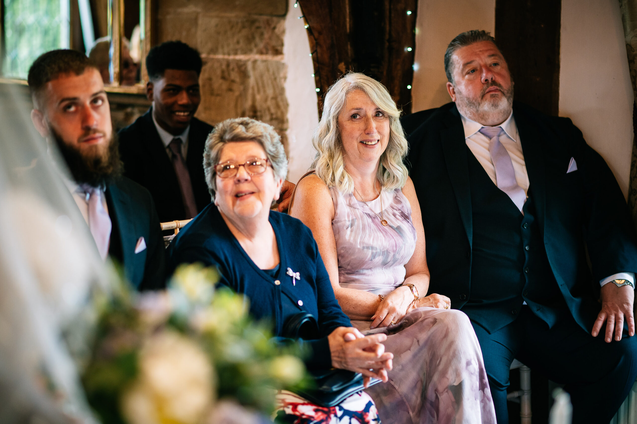 mother of the groom looking on with tears in her eyes