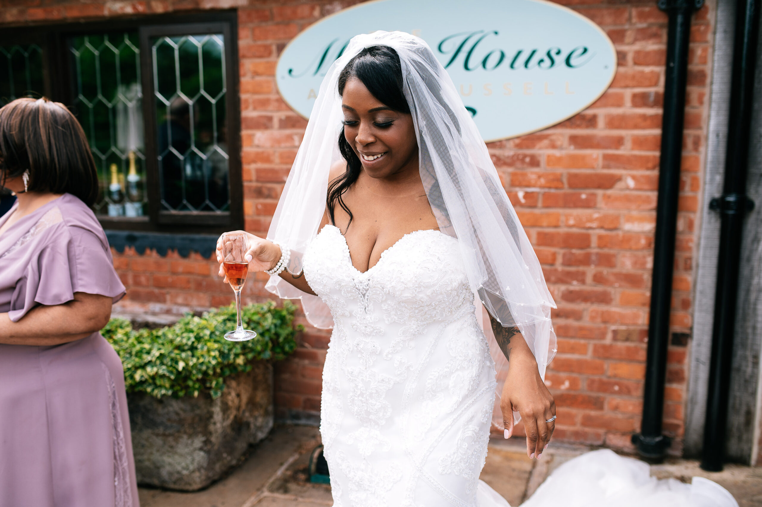 bride with a drink outside the moat house in staffordshire