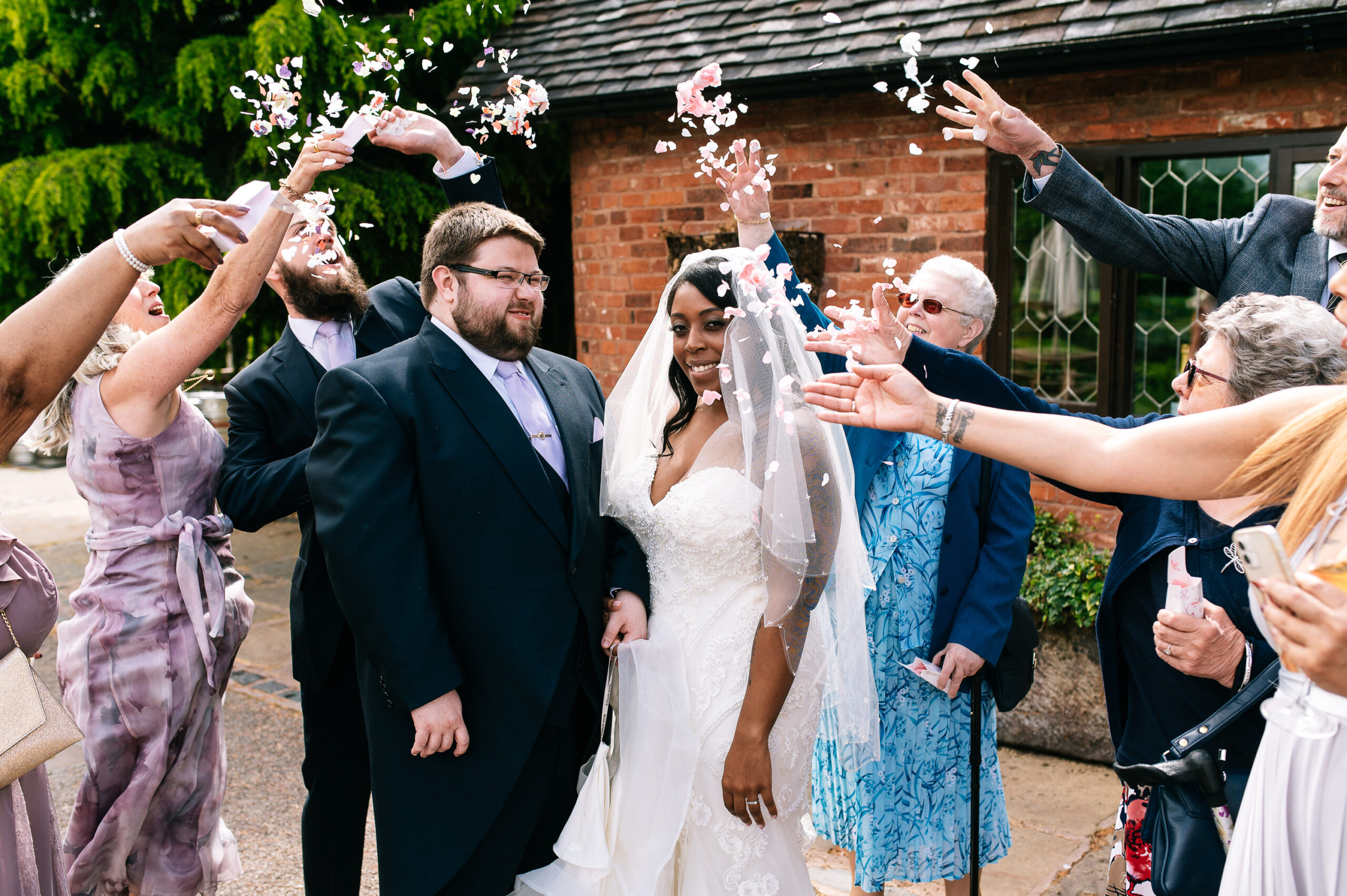 guests throwing confetti at the moat house