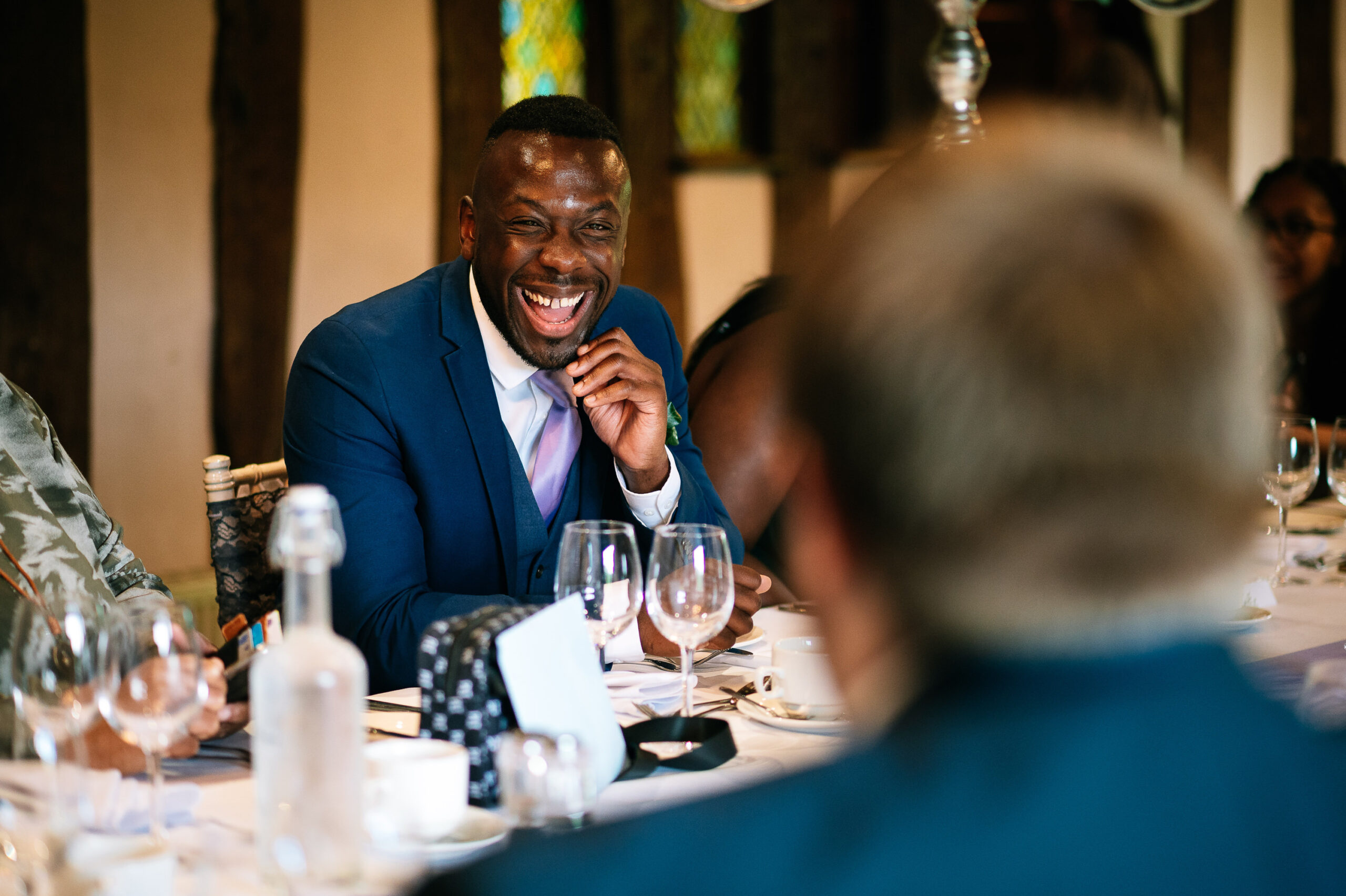 laughing guest sat down for the wedding breakfast